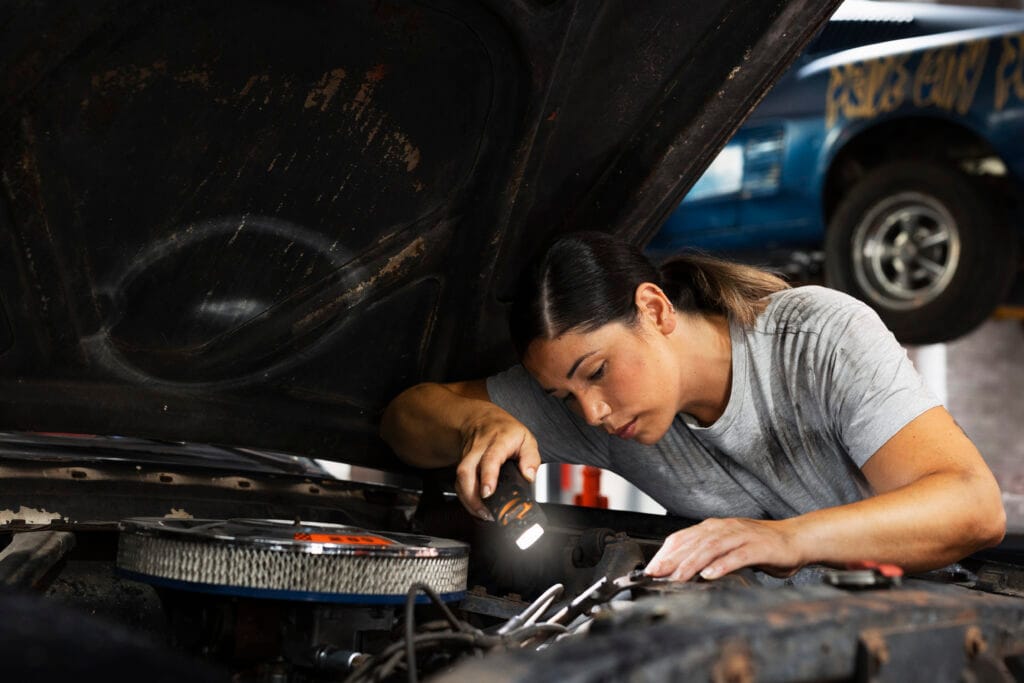 Mechanic woman is repairing car